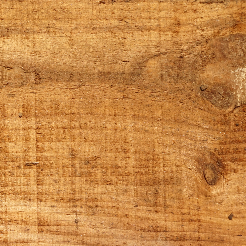 Primer plano de la textura y veta natural de madera de pino ecológica tratada en tono marrón para traviesas de exterior.