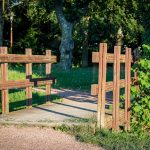 Vallas de madera tratada para cerramientos de jardín y parques construidas con traviesas de tren rústicas.